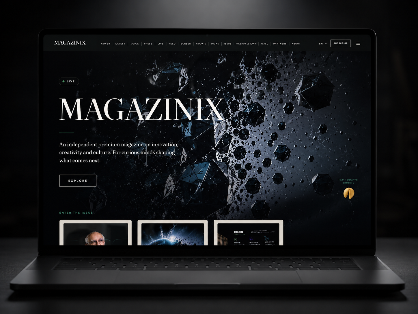 MAGAZINIX digital magazine shown on a laptop in a darkened room — the editorial homepage with the MAGAZINIX wordmark over a cinematic fractured-crystal cover image.